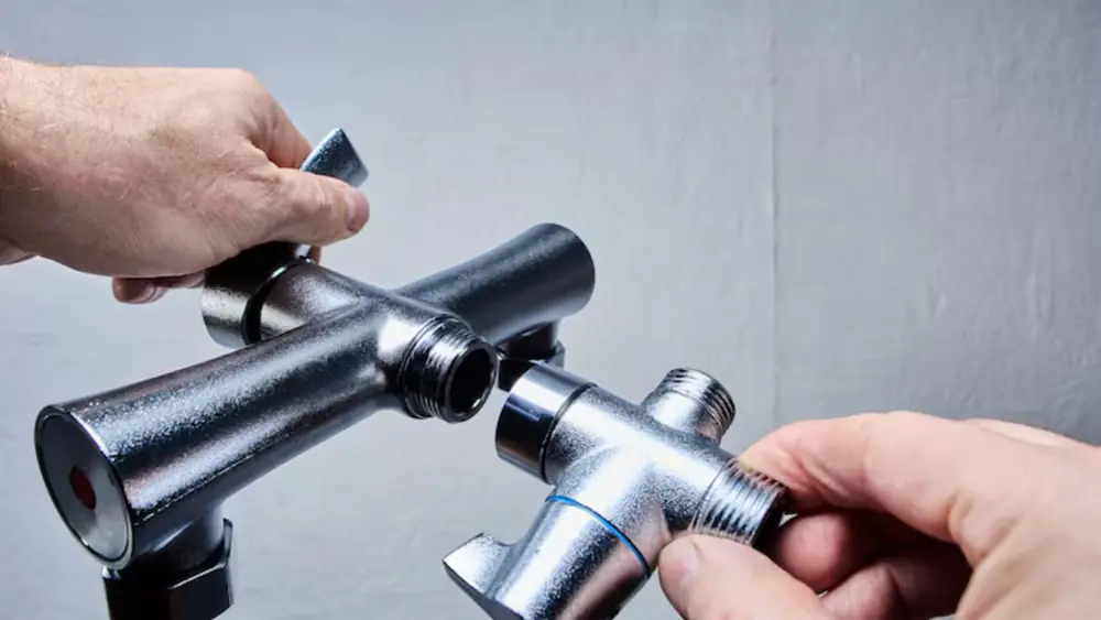 Hands holding a tub diverter valve