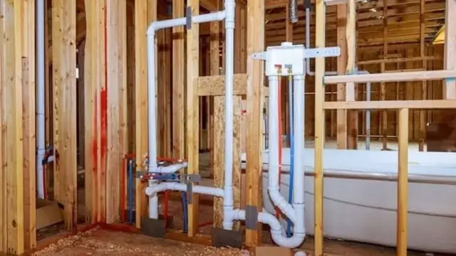 White drain and vent pipes in open wall framing